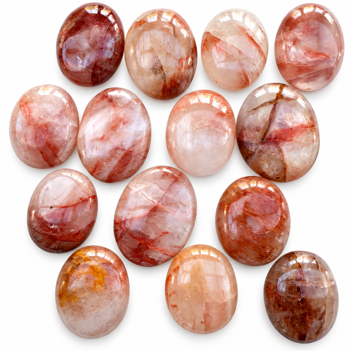 Group of polished Fire Quartz palm stones showing natural variations