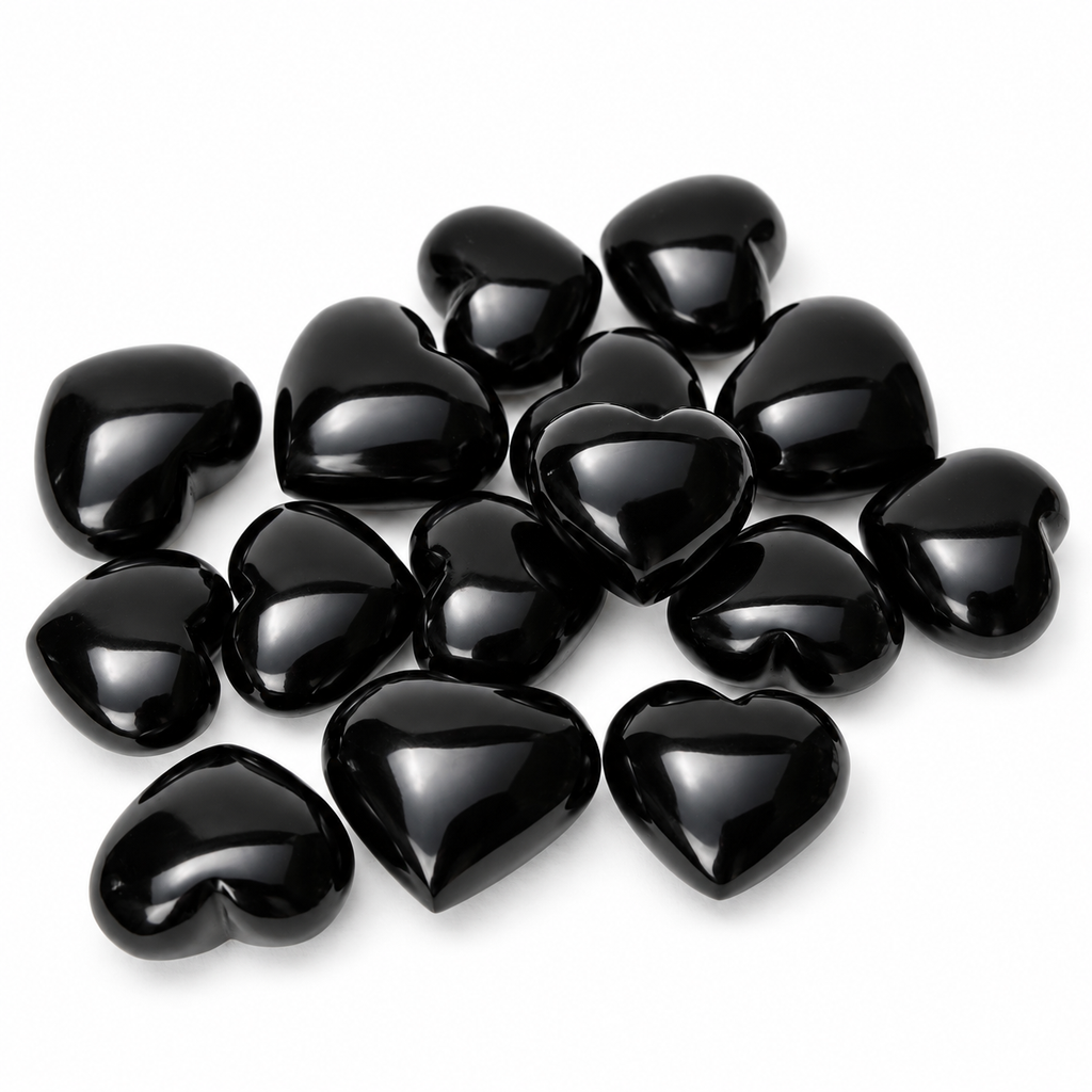 Group of polished Black Obsidian heart-shaped palm stones showing natural variations