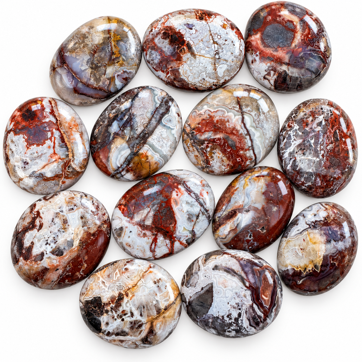 Group of polished Crazy Lace Agate palm stones showing natural variations