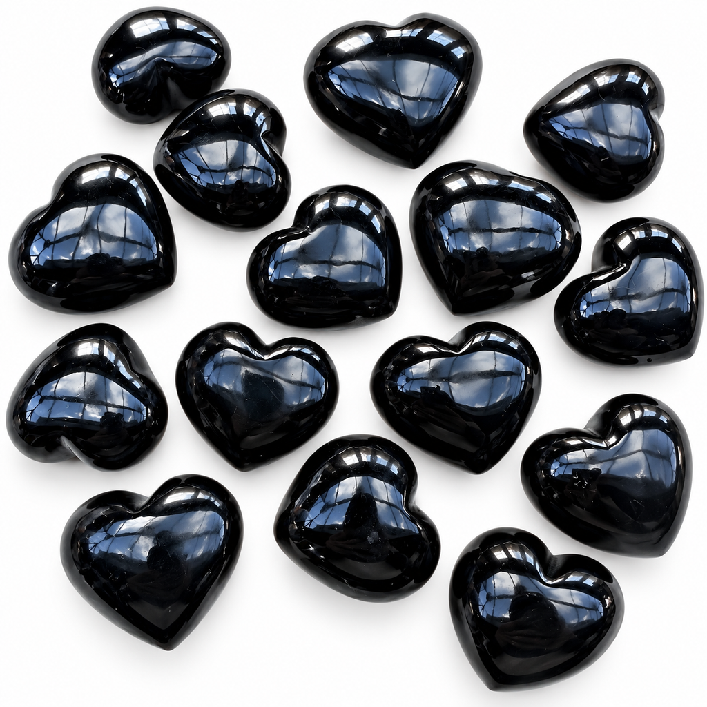 Collection of polished Black Obsidian heart palm stones showing natural variations