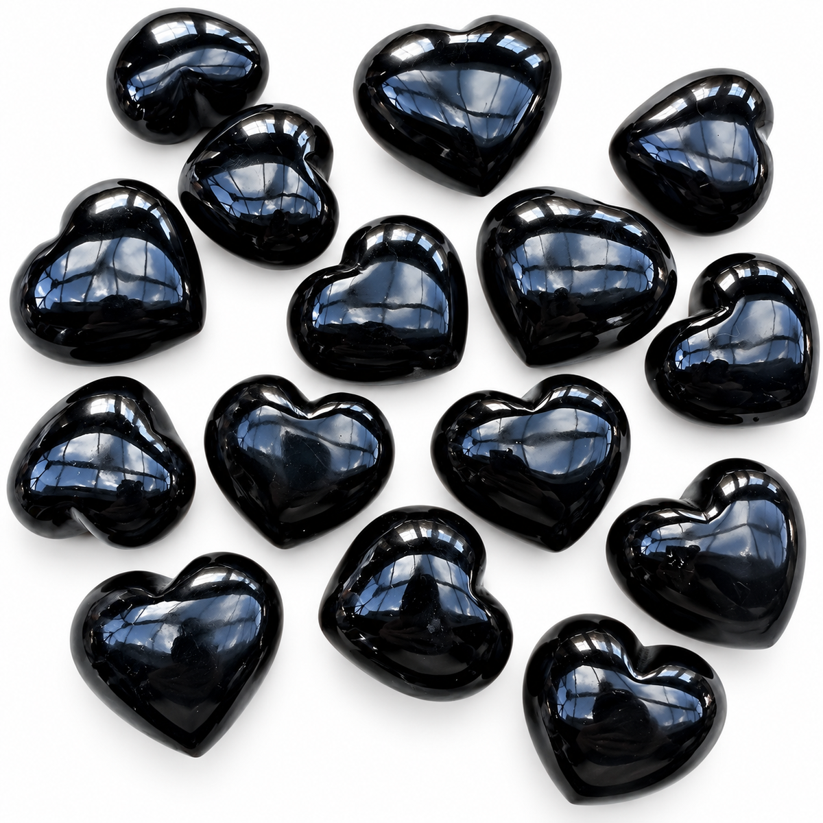 Collection of polished Black Obsidian heart palm stones showing natural variations