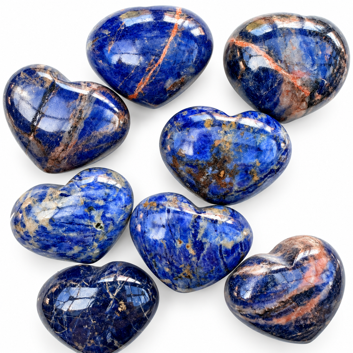 Group of polished Sodalite heart-shaped palm stones showing natural variations