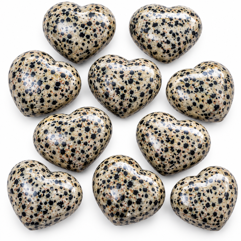 Group of polished Dalmatian Jasper heart-shaped palm stones showing natural variations