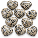 Group of polished Dalmatian Jasper heart-shaped palm stones showing natural variations