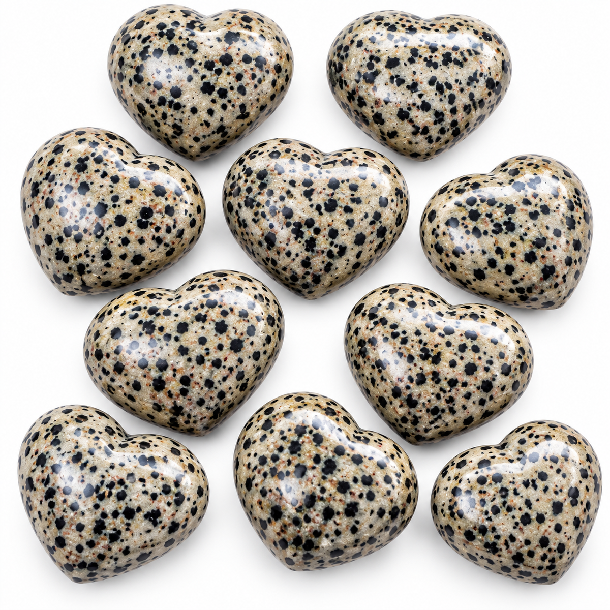 Group of polished Dalmatian Jasper heart-shaped palm stones showing natural variations