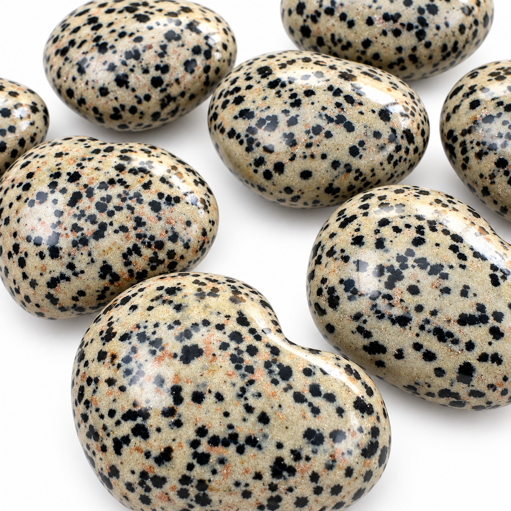 Group of polished Dalmatian Jasper heart-shaped palm stones showing natural variations