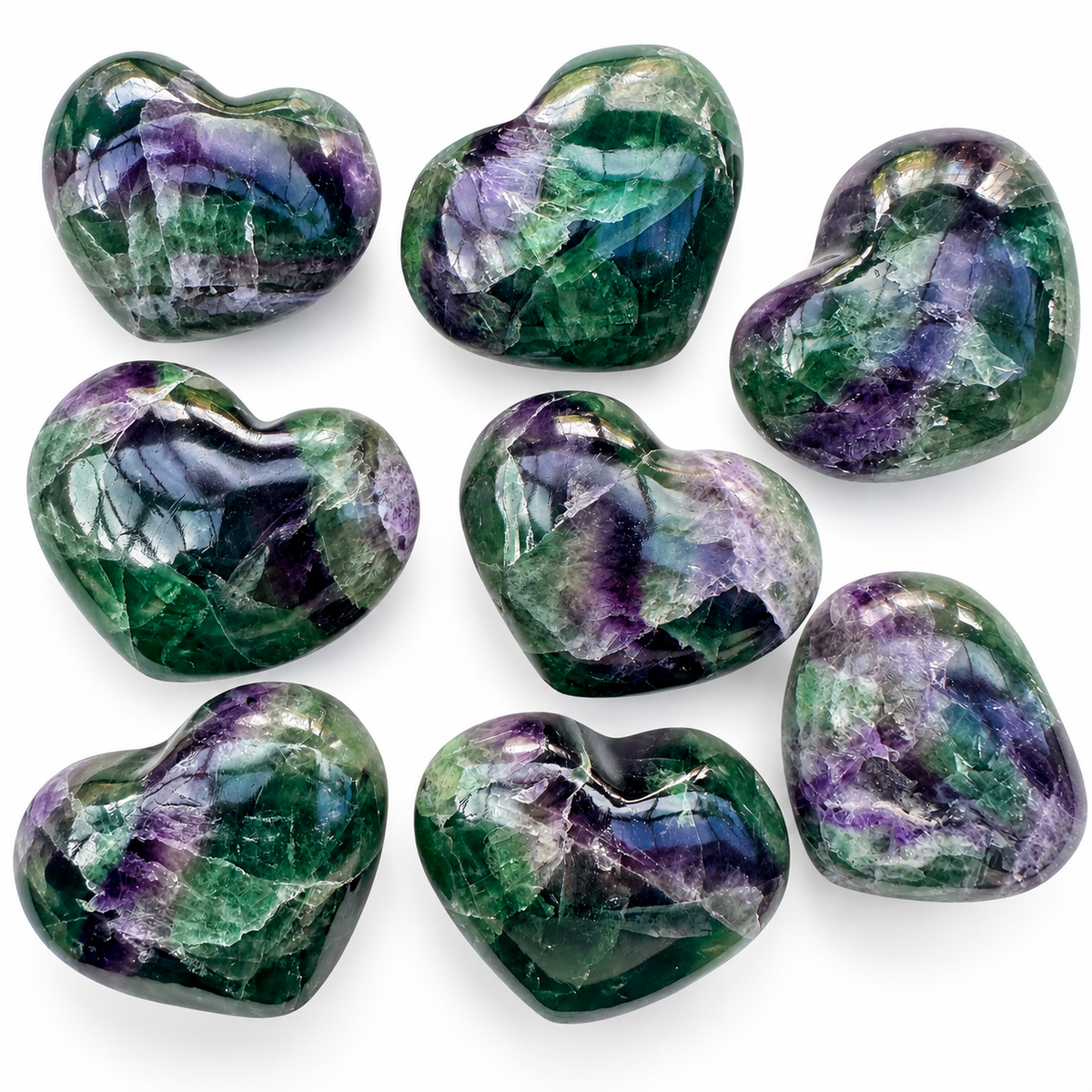 Collection of polished green and purple Rainbow Fluorite crystal hearts