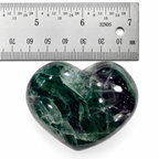 Polished Rainbow Fluorite heart-shaped palm stone beside ruler for size reference