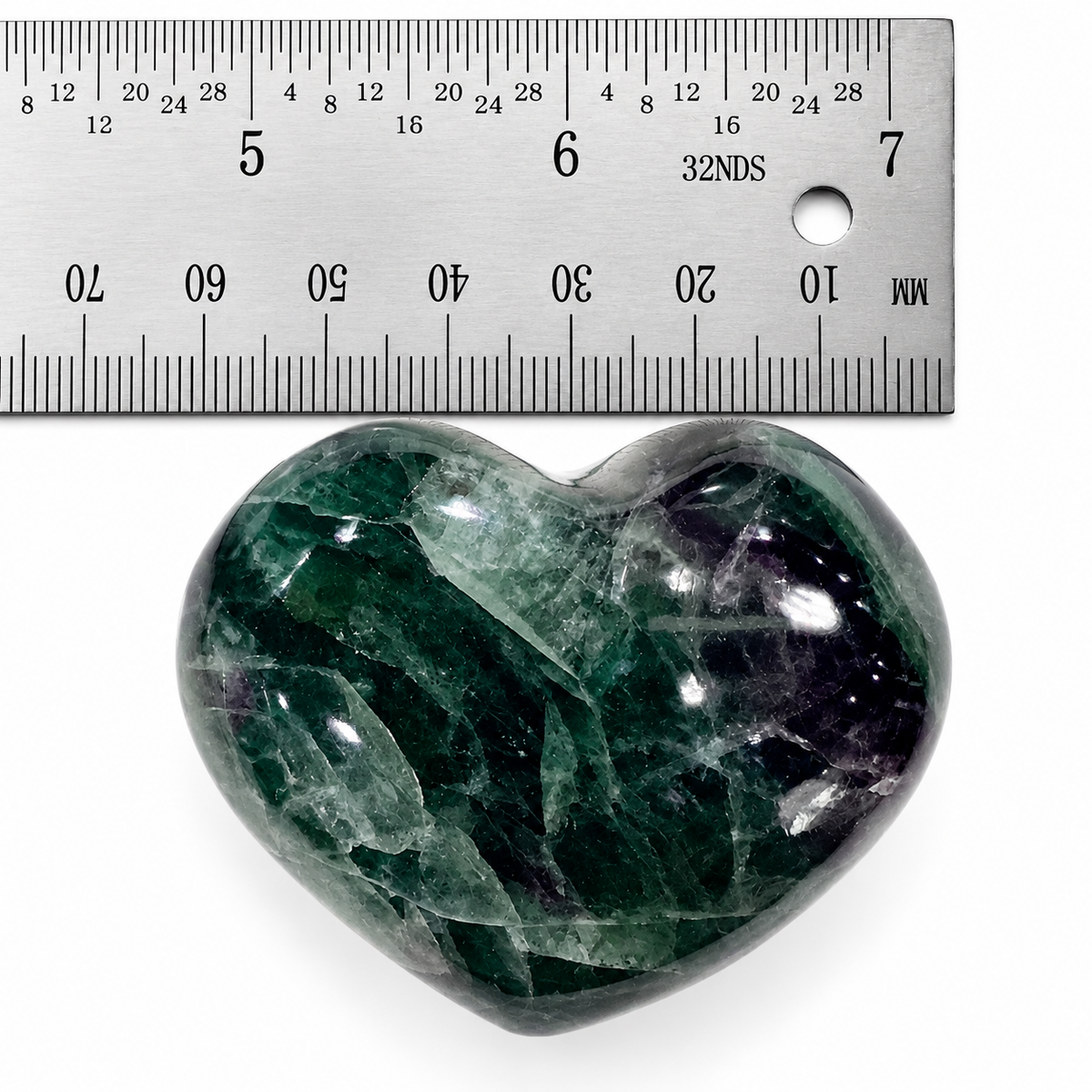 Polished Rainbow Fluorite heart-shaped palm stone beside ruler for size reference