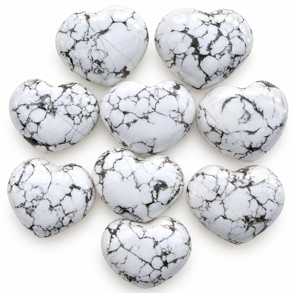 Group of polished Howlite heart-shaped palm stones showing natural variations
