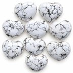 Group of polished Howlite heart-shaped palm stones showing natural variations