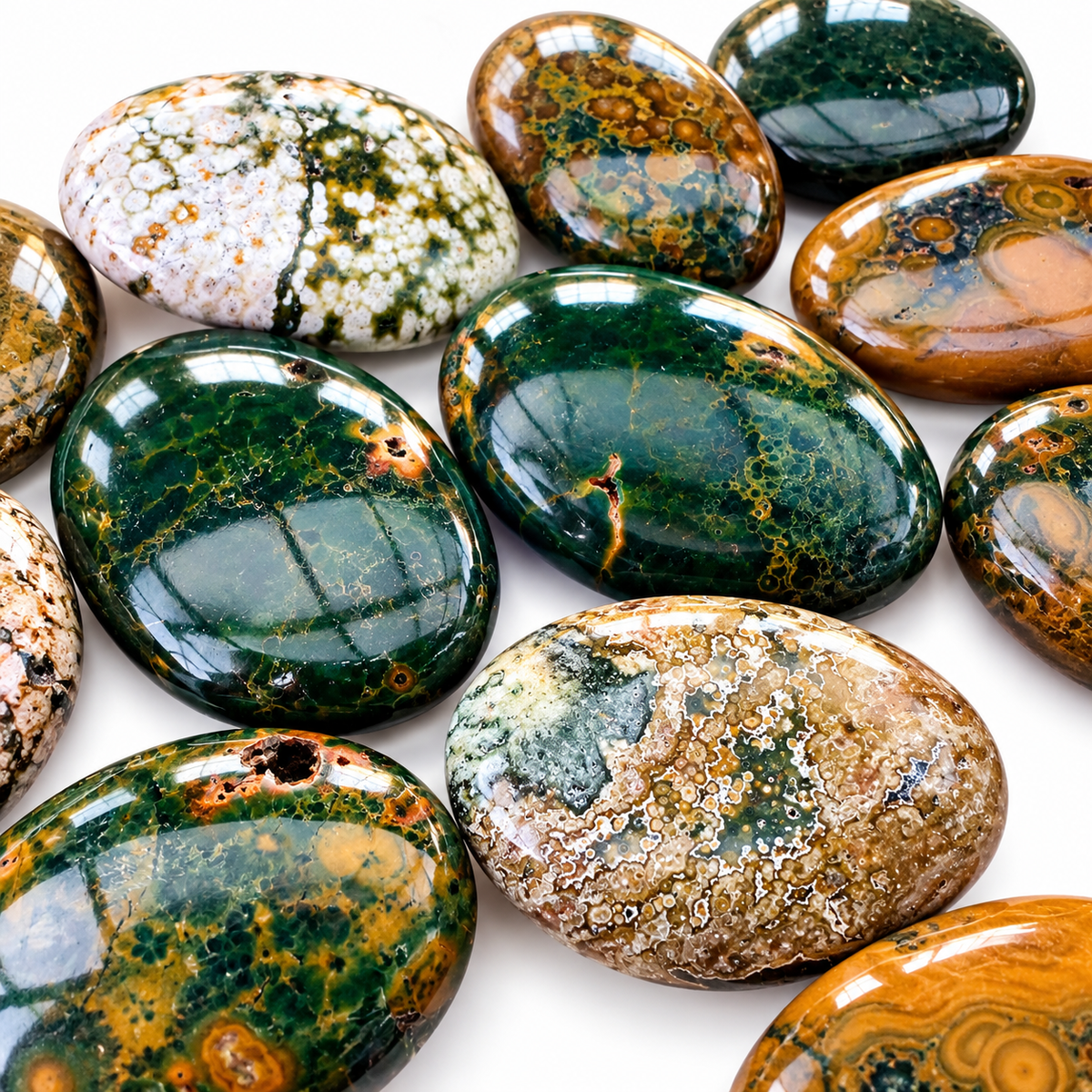 Group of polished Ocean Jasper palm stones showing natural variations