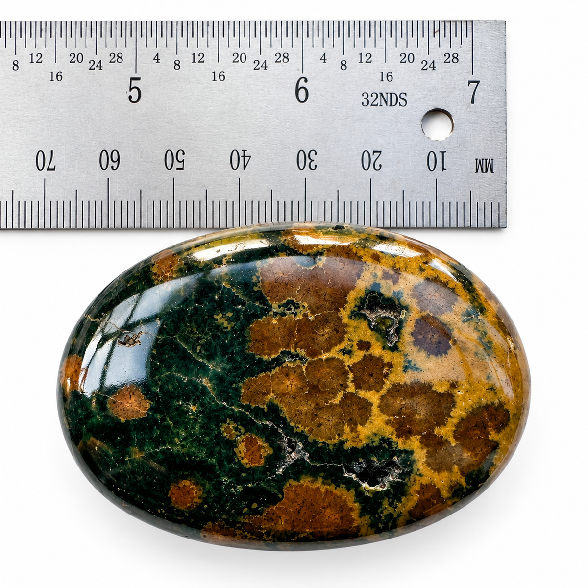 Ocean Jasper palm stone shown beside ruler for size reference