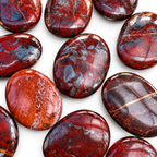 Collection of polished Red Jasper Hematite palm stones with natural variations