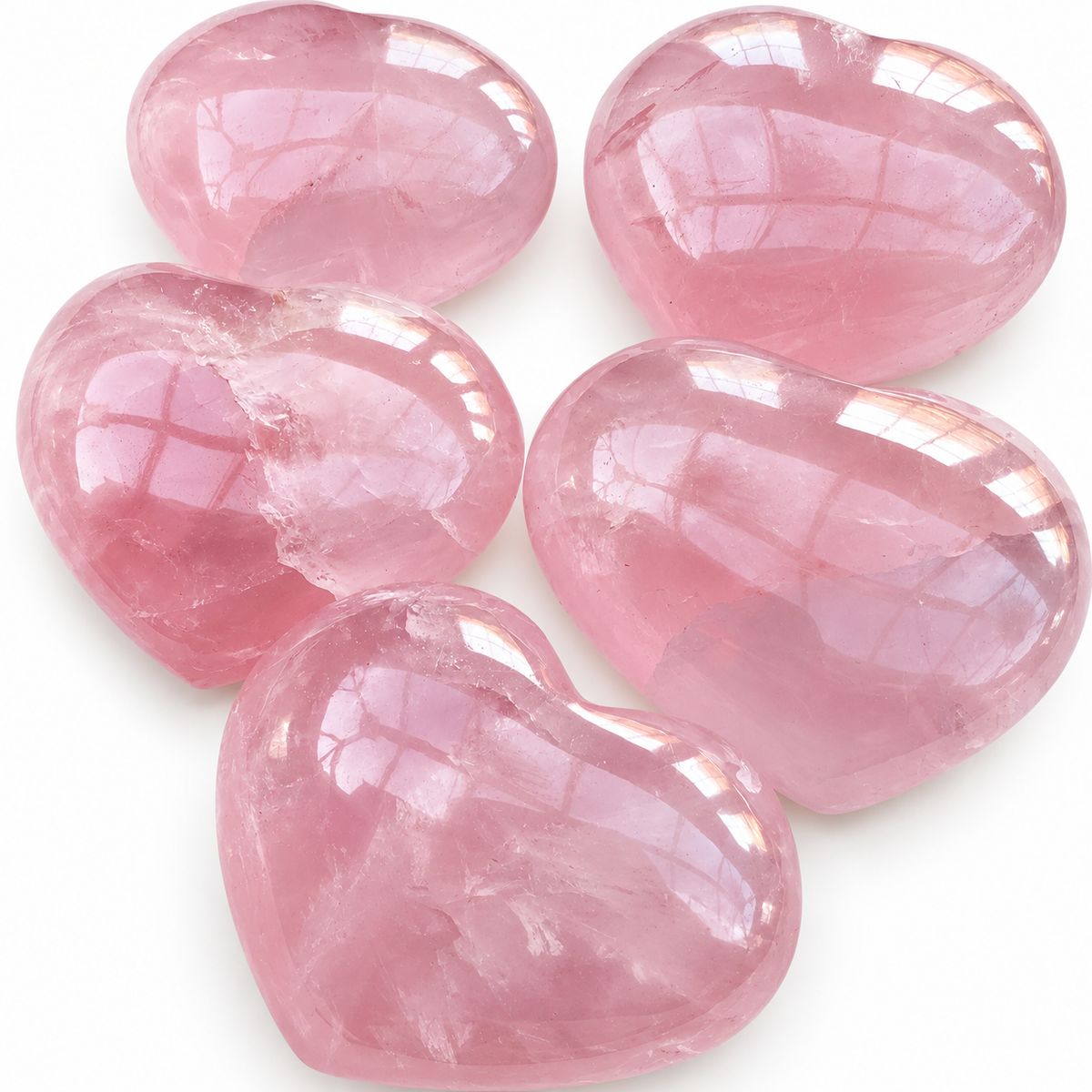 Close-up group of polished pink Rose Quartz heart-shaped palm stones
