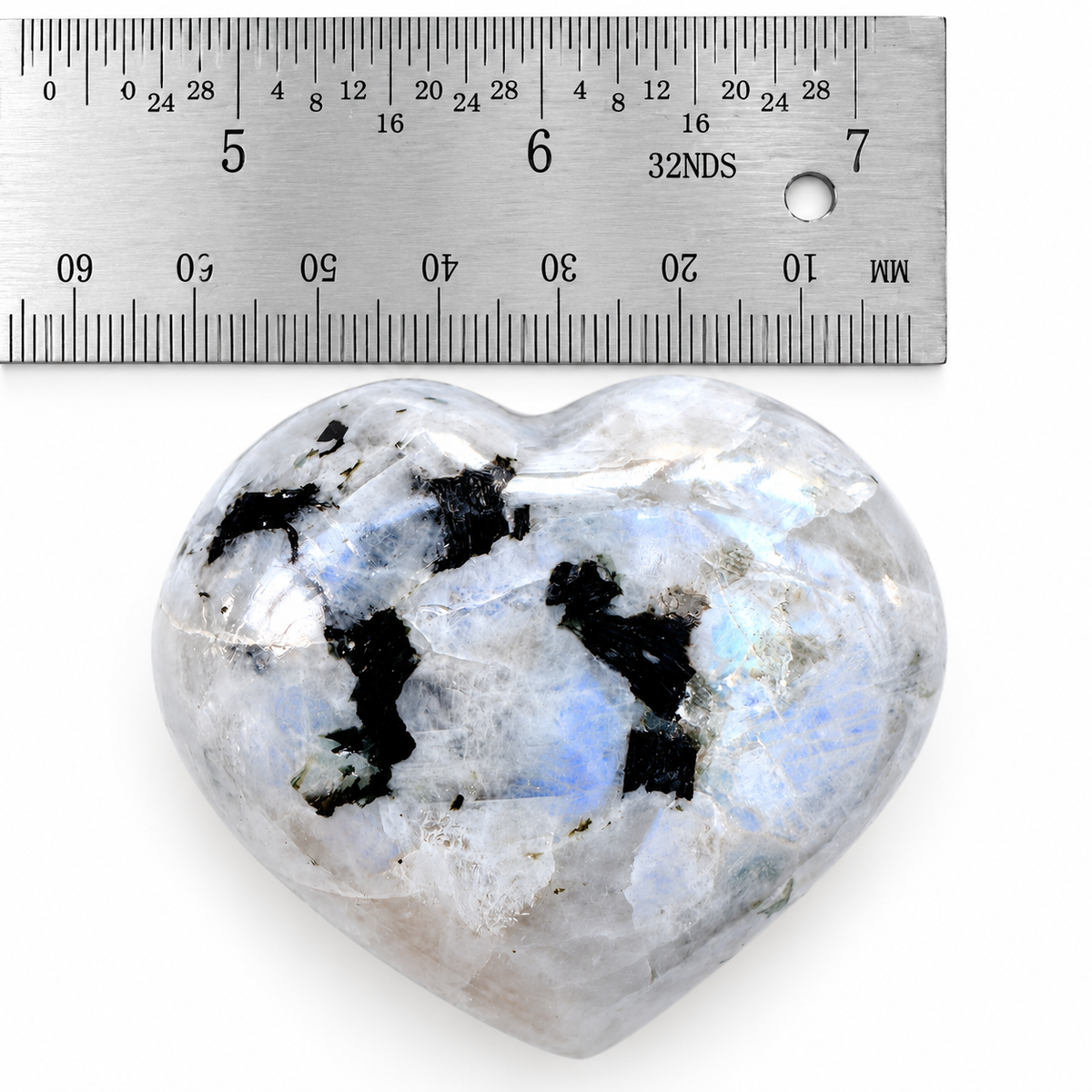 Rainbow Moonstone palm stone shown beside ruler for size reference