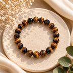Tiger Eye polished bead bracelet photographed in soft sunlit neutral setting