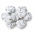 Group of polished Howlite heart-shaped palm stones showing natural variations