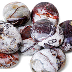 Polished Crazy Lace Agate palm stone showing natural colour and markings