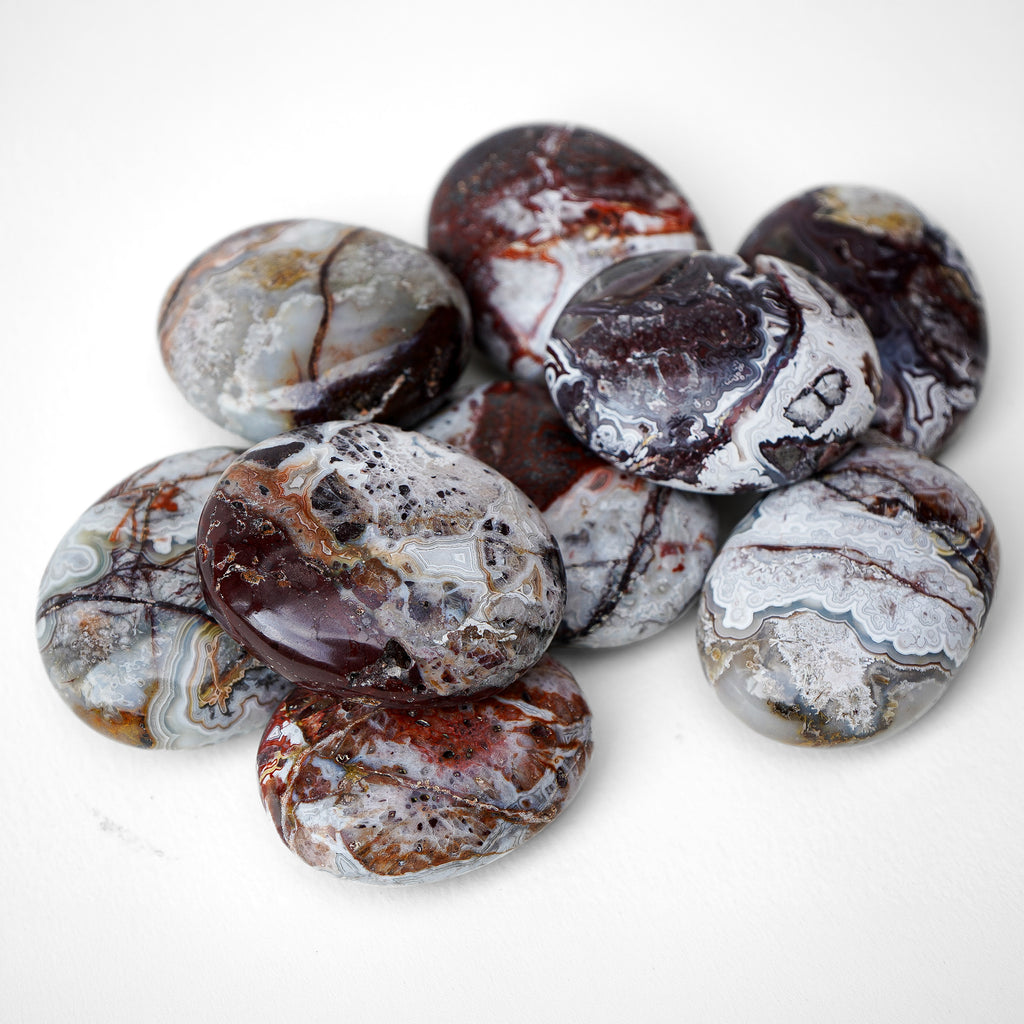 Polished Crazy Lace Agate palm stone showing natural colour and markings