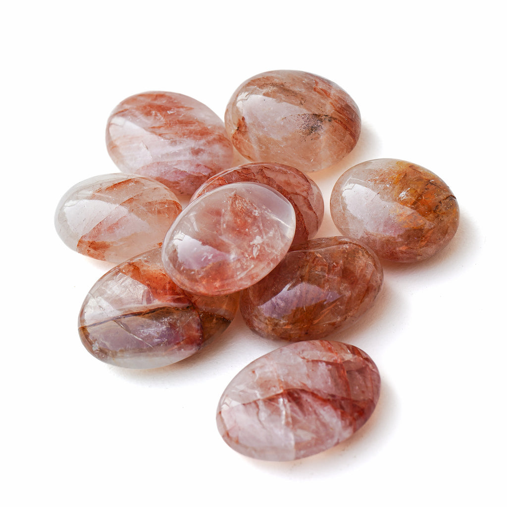 Polished Fire Quartz palm stone showing natural colour and markings